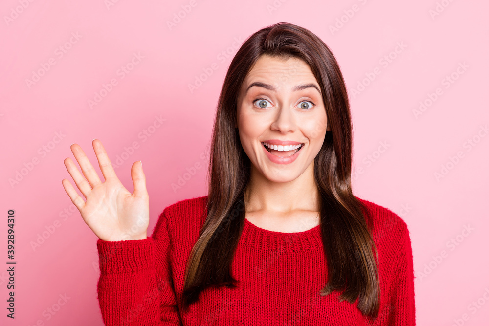 Photo of young charming woman wave hand look camera wear red pullover isolated pink color background
