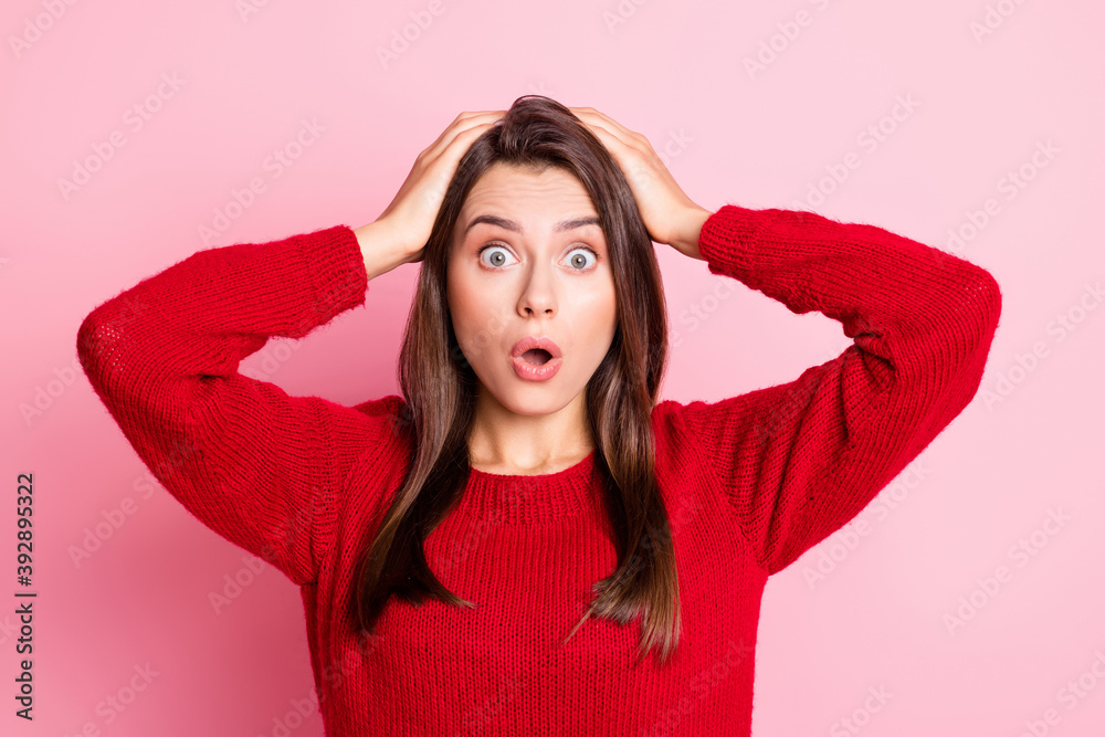 Photo of young charming girl shocked hands head staring camera wear red sweater isolated pink color background Photo of young charming girl shocked hands head staring camera wear red sweater isolated pink color background