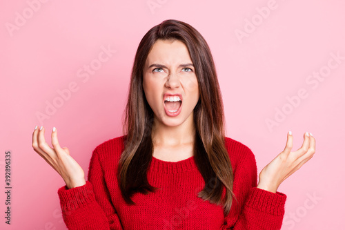 Portrait photo of aggressive outraged young girl wearing red outfit gesturing with both hands grinning opened mouth looking up annoyed isolated on pink color background