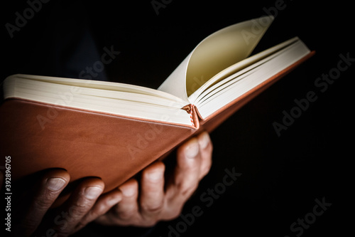 Open book in man hands.