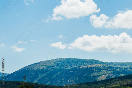 landscape mountain with green forest and blue sky with clouds