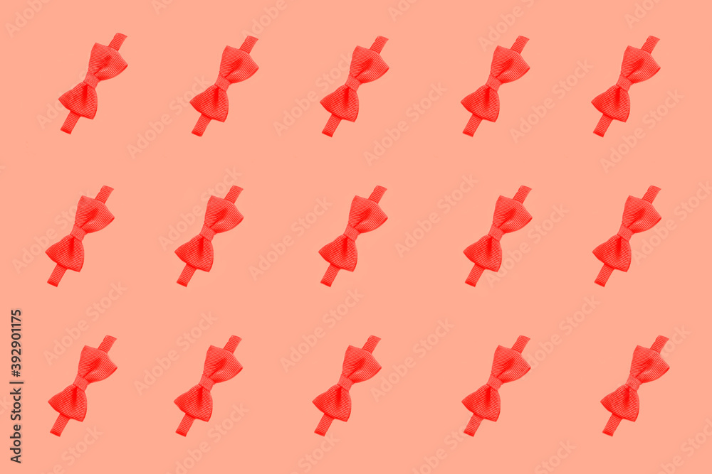 red bow pattern. red bow on a pink background. ribbon