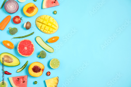 Fototapeta Naklejka Na Ścianę i Meble -  Flat lay composition with fresh organic fruits and vegetables on light blue background. Space for text