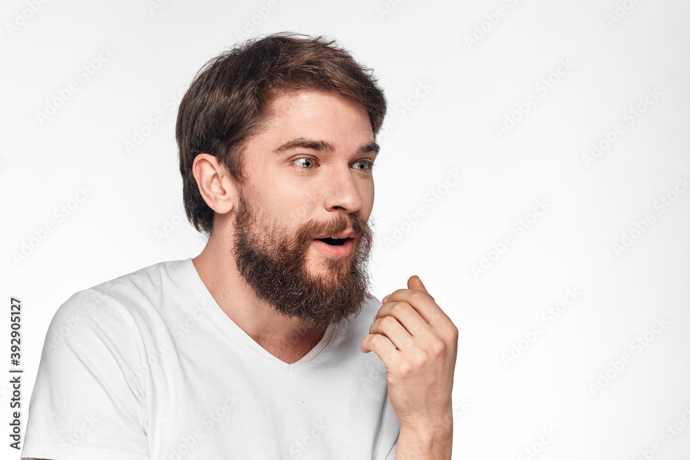 cheerful emotional bearded man gesturing with his hands close-up light background cheerful emotional bearded man gesturing with his hands close-up light background