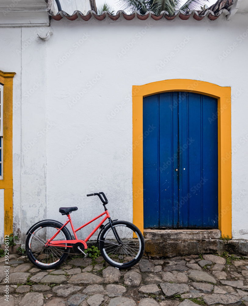 Red bicycle in front of a house Red bicycle in front of a house