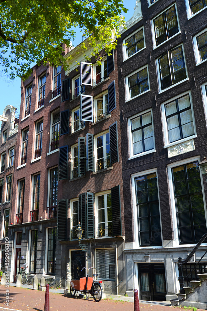 An empty street in Amsterdam, The Netherlands. Traditional dutch architecture. Vertical view