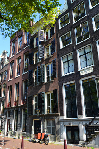 An empty street in Amsterdam, The Netherlands. Traditional dutch architecture. Vertical view © Zhanko