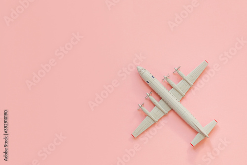 a toy plane on a bright colored background, the concept of resuming flights around the world after the coronavirus, restoring the finances of airlines and tour operators.