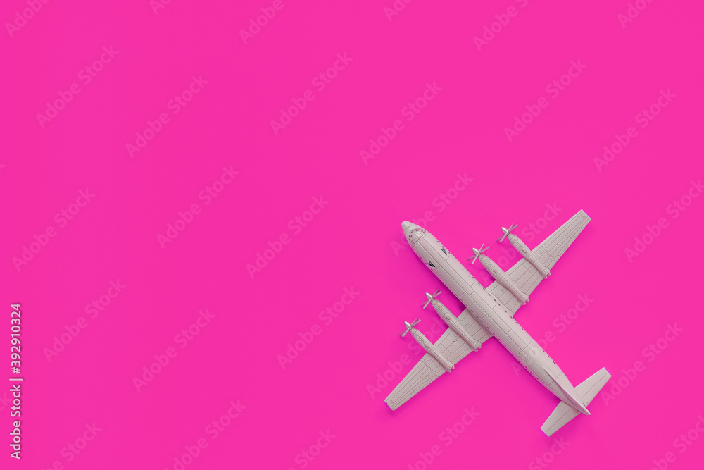 a toy plane on a bright colored background, the concept of resuming flights around the world after the coronavirus, restoring the finances of airlines and tour operators. a toy plane on a bright colored background, the concept of resuming flights around the world after the coronavirus, restoring the finances of airlines and tour operators.