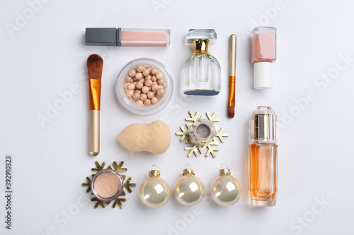 Flat lay composition with decorative cosmetic products on light background. Winter care