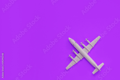 a toy plane on a bright colored background, the concept of resuming flights around the world after the coronavirus, restoring the finances of airlines and tour operators.