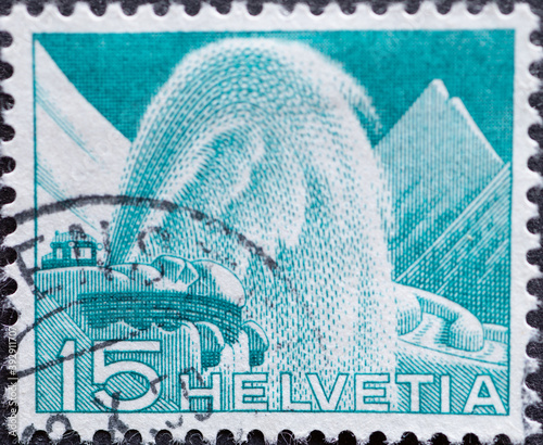 Switzerland - Circa 1949 : a postage stamp printed in the swiss showing a Swiss Post snow blower in action with snow fountaine photo