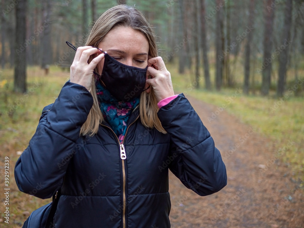 Beautiful european Women Wearing Protective Mask Outside Pretty young girl in medical black face mask in a forest. covid19 concept. modern reality. copy space. 2020, allergy. Autumn season. Copy space Beautiful european Women Wearing Protective Mask Outside Pretty young girl in medical black face mask in a forest. covid19 concept. modern reality. copy space. 2020, allergy. Autumn season. Copy space