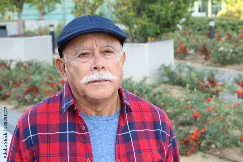 Pensioner with serious expression outdoors