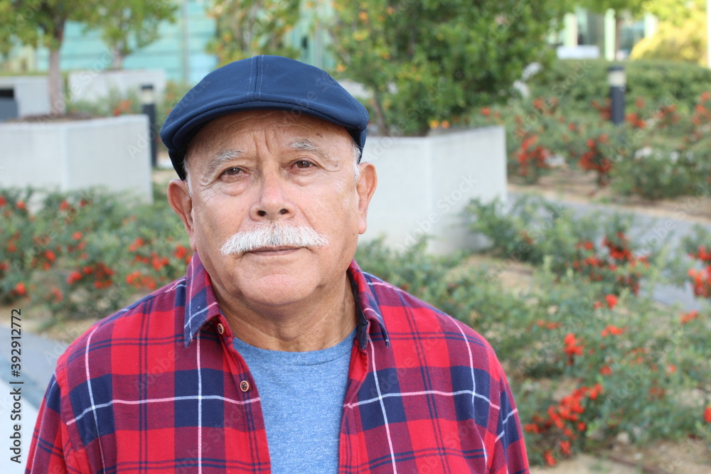 Pensioner with serious expression outdoors Pensioner with serious expression outdoors