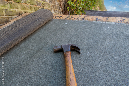 Shed or roof felt being fitted to a residential garden shed