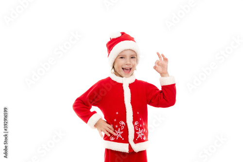 Little boy in Santa Claus costume shows that everything will be OK