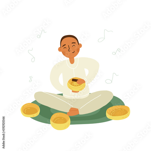 An Asian boy or young man do singing bowls healing therapy sitting on the mat, a lot of metallic bowls nearby.