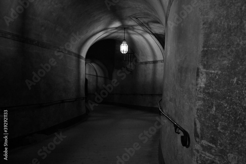 Arched illuminated corridor in the medieval Castle in Cesky Krumlov, Southern Bohemia. Black and white photo