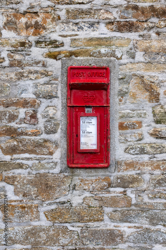 old red post box in wall