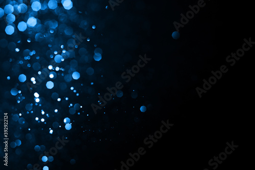 Abstract bokeh on dark blue background. Holiday concept