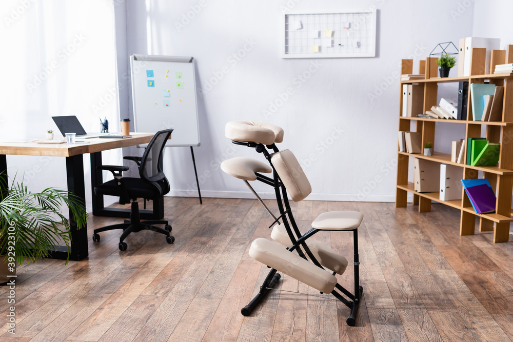 Interior of spacious office with modern design and massage chair Interior of spacious office with modern design and massage chair