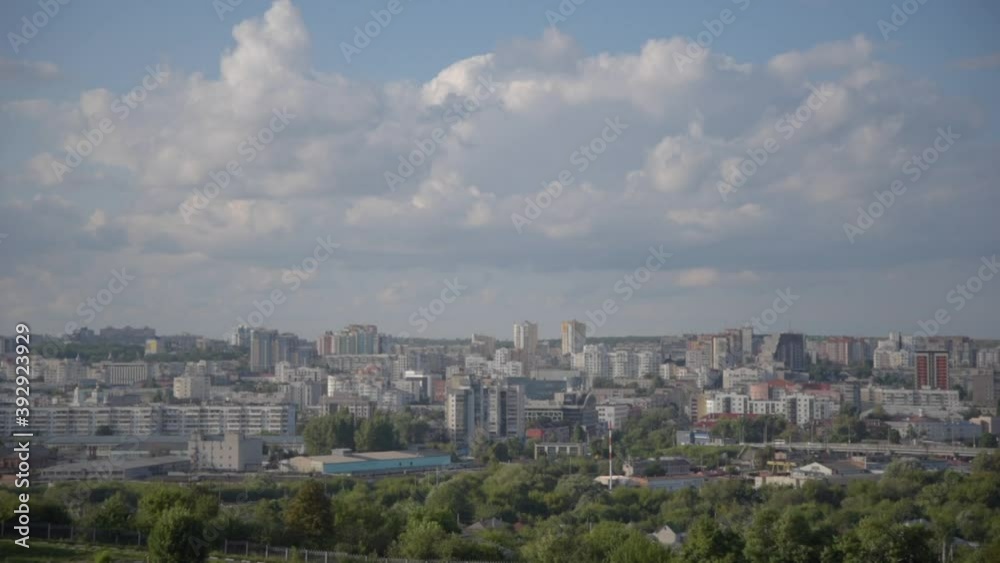panoramic view of the city, residential buildings, shopping centers, green trees, transport against the backdrop of a blue cloudy sky. can be used for time lapse panoramic view of the city, residential buildings, shopping centers, green trees, transport against the backdrop of a blue cloudy sky. can be used for time lapse