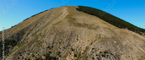 Banner of a huge hill above the old Bosnian village of Lukomir, which is quite devoid of vegetation due to soil erosion.