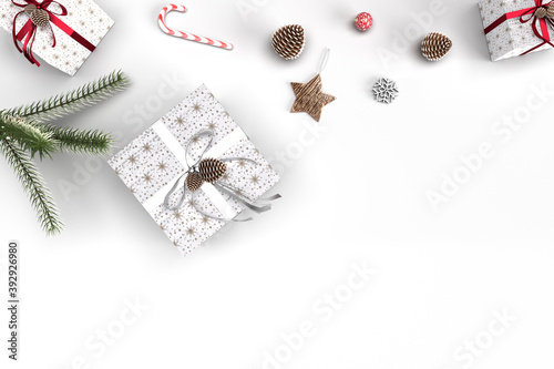 Fototapeta Naklejka Na Ścianę i Meble -  Mock up christmas background with decorations,christmas gift, knitted blanket, pine cones, fir branches on wooden background. Flat lay, top view