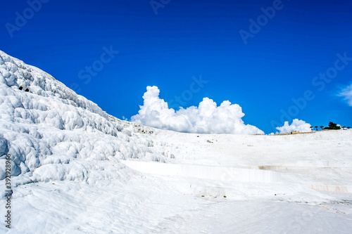 Perfect white landscape by clouds and travertine hills and pools - Pamukkale.