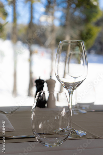 View from the restaurant with glasses of wine to the snowy slopes.