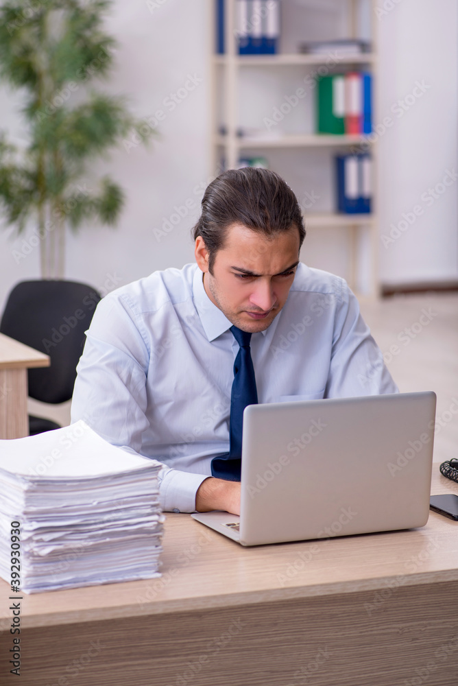 Young male employee sitting in the office Young male employee sitting in the office