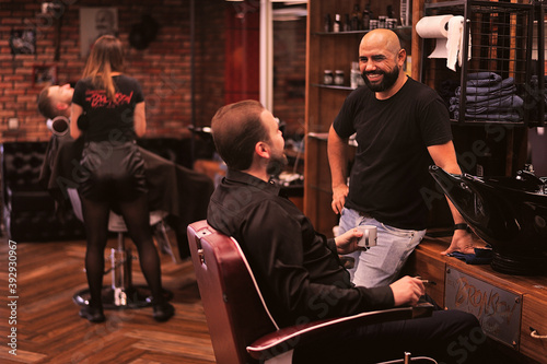 Brutal barber shaves a man in a barbershop