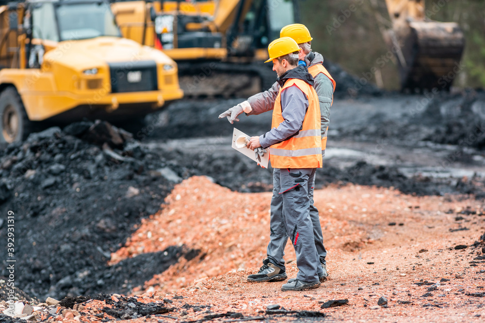 Two quarry workers discussing what to do next Two quarry workers discussing what to do next
