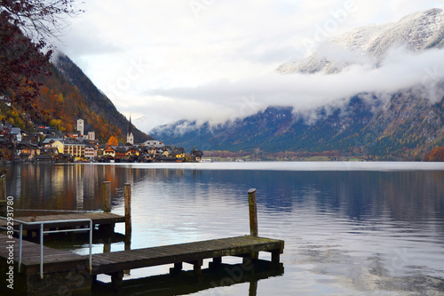 Hallstatt town view in a foggy day and clouds between the mountains. Amazing autumn cityscape, Austria, Salzkammergut region