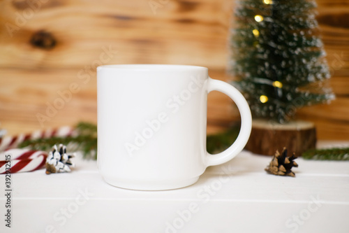 White cup  Christmas mock up, New Year decorations, candles and tree