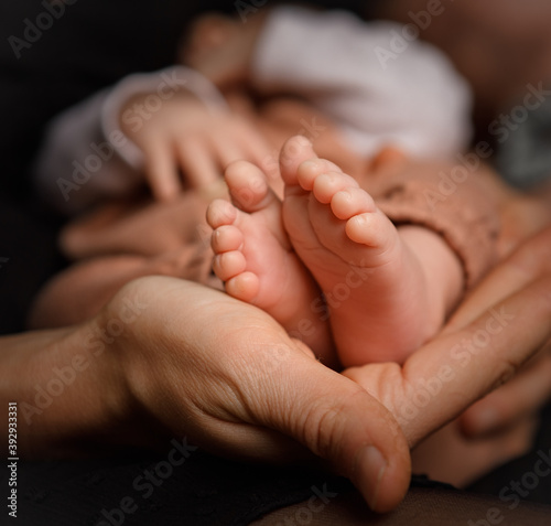 newborn feet in hands