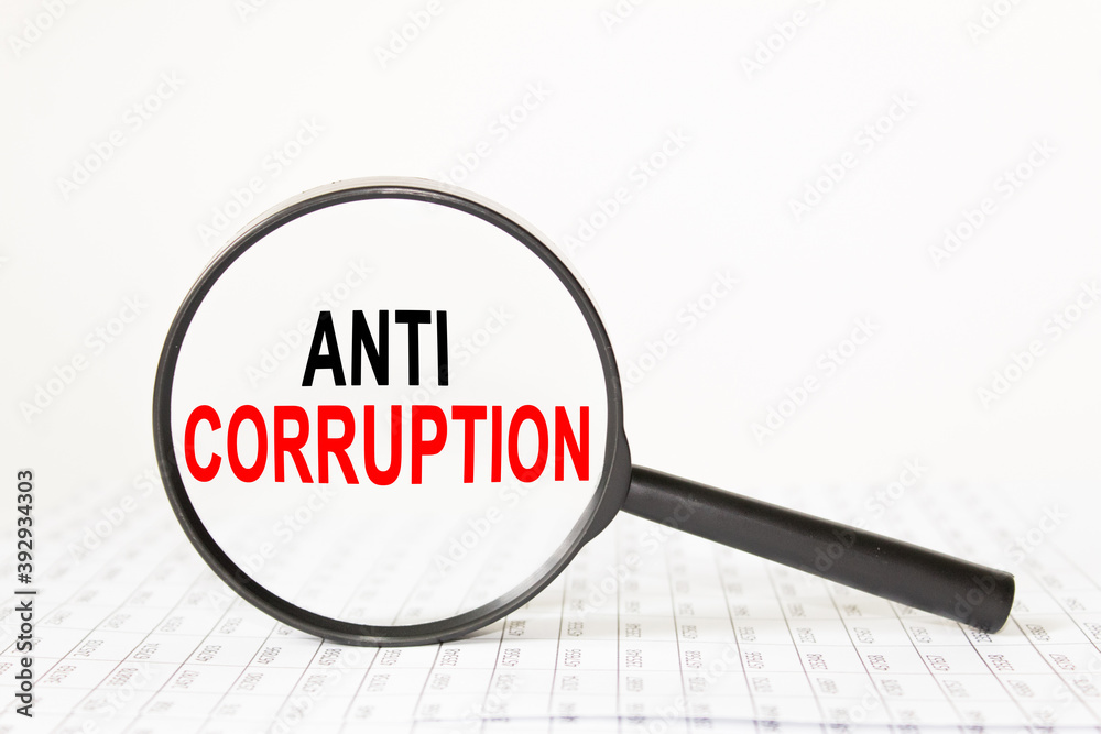 words ANTI CORRUPTION in a magnifying glass on a white background. business concept words ANTI CORRUPTION in a magnifying glass on a white background. business concept
