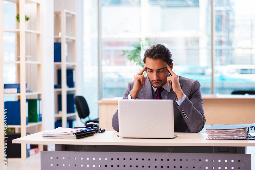 Young male employee working in the office