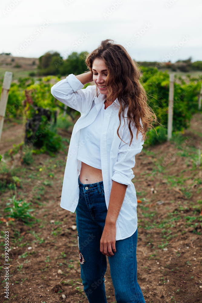 Beautiful woman walks on a picnic in the vineyard Beautiful woman walks on a picnic in the vineyard