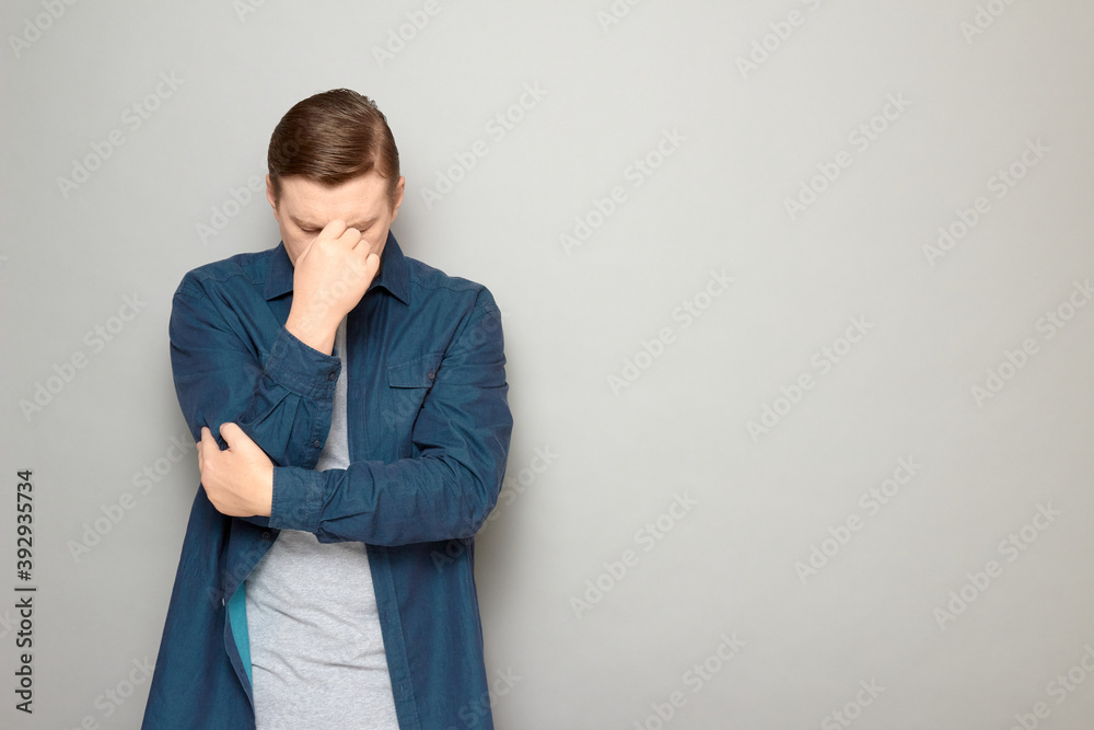 Portrait of thoughtful tired mature man touching bridge of his nose Portrait of thoughtful tired mature man touching bridge of his nose