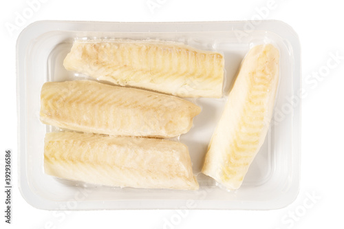Фотография Frozen vacuum packed cod fish loins or fillets in plastic, isolated on white background
