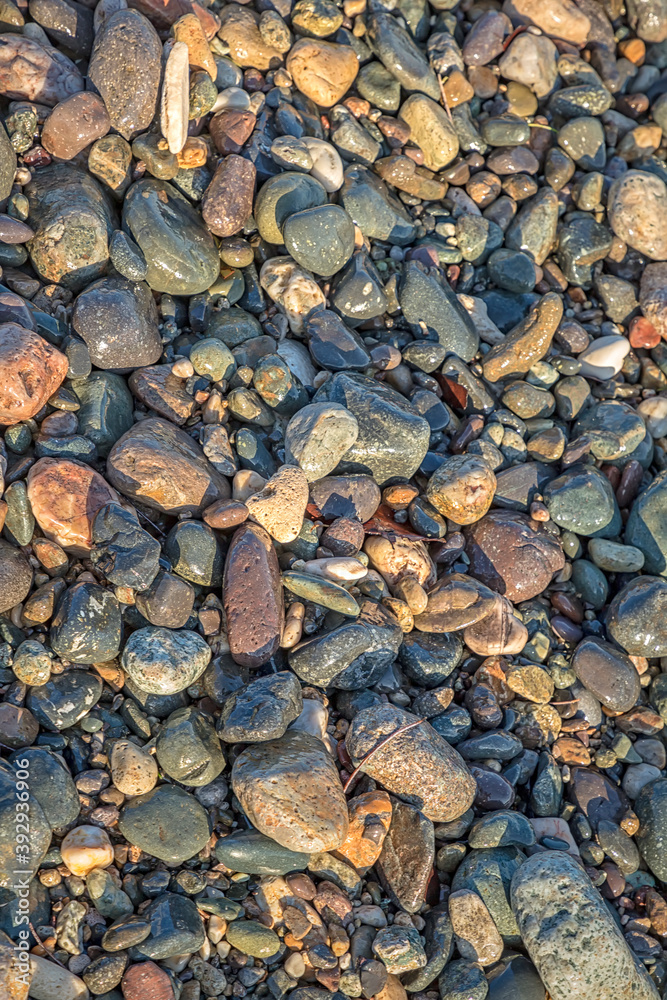 The surface of many river stones. Top view. Beautiful stones background The surface of many river stones. Top view. Beautiful stones background