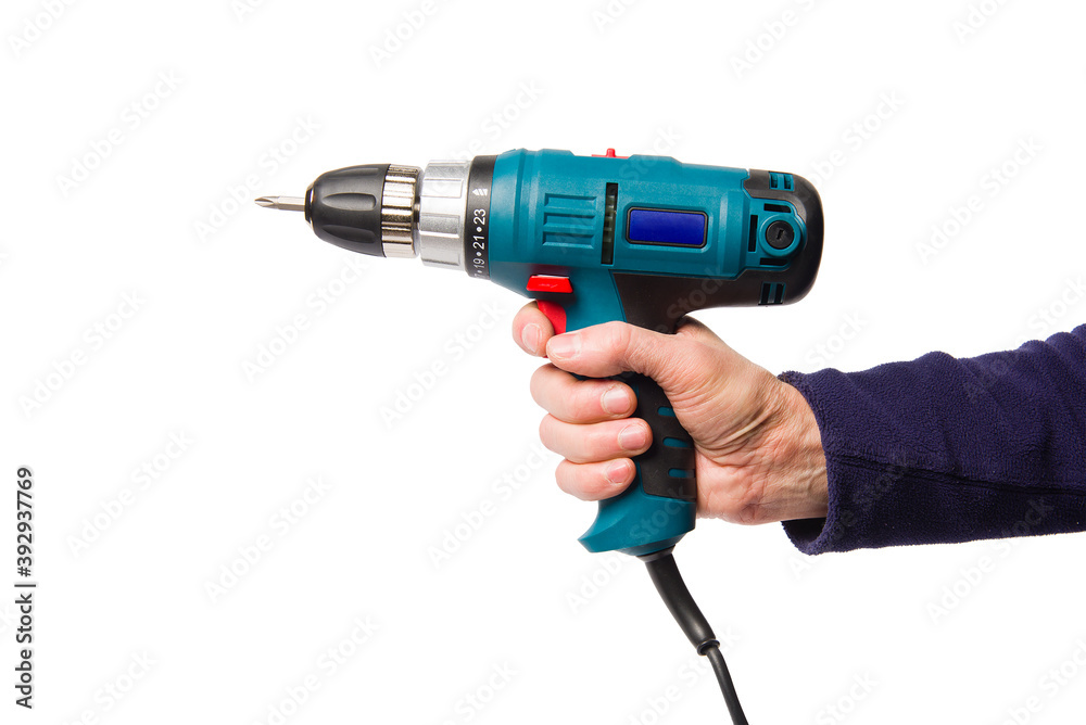 A man's hand holds an electric screwdriver. A man's hand holds an electric screwdriver.