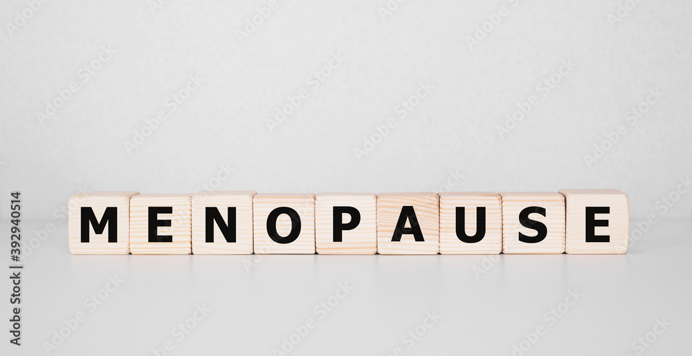 Fototapeta Menopause word written on wood block. menopause text on table, concept.