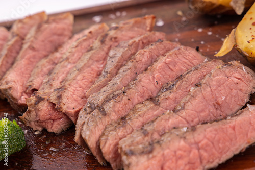  Close up sliced steak.  Delicious steak on wooden board.