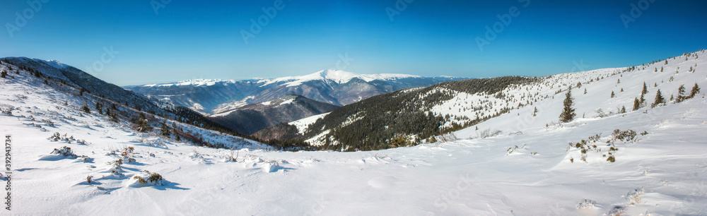 Winter mountains, panorama - snow-capped peaks of the  Alps. Panoramic landscape with beautiful snow covered summits in sunny day. Aerial view of high peaks.