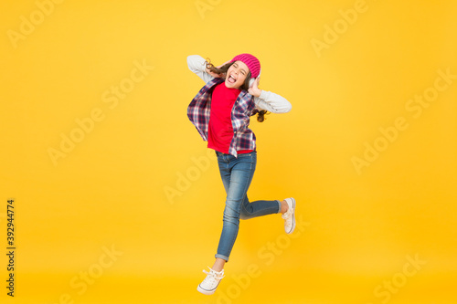 Let the music take you away. Energetic girl move to music. Little kid enjoy singing yellow background. Headphones technology. Modern life. Happy dance. Play the moment © be free