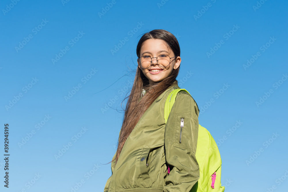 A new sky, a new life. Happy girl carry backpack outdoors. Traveling and wanderlust. Autumn vacation. Travel destination. Discovery and adventure. Look up wanderlust A new sky, a new life. Happy girl carry backpack outdoors. Traveling and wanderlust. Autumn vacation. Travel destination. Discovery and adventure. Look up wanderlust