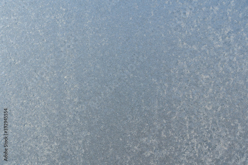 Frozen window glass covered with frost